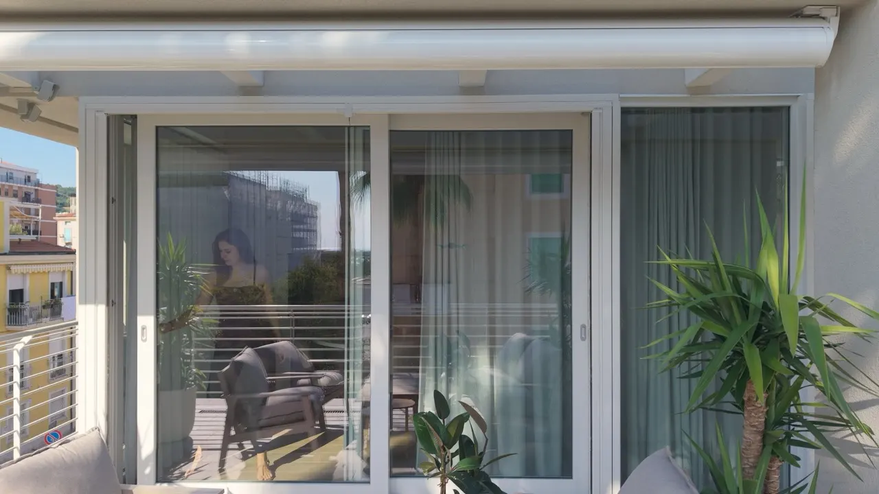 Aluminium sliding door open onto a furnished terrace