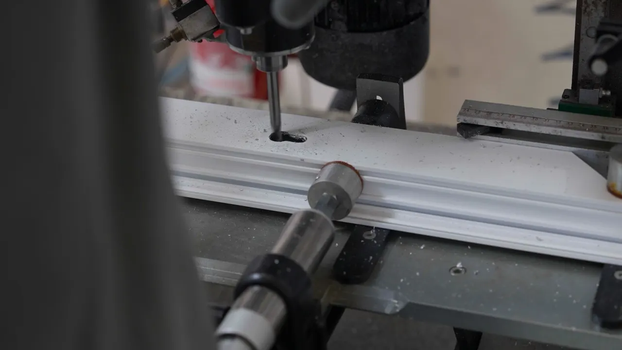 A profile being drilled on the machine tool