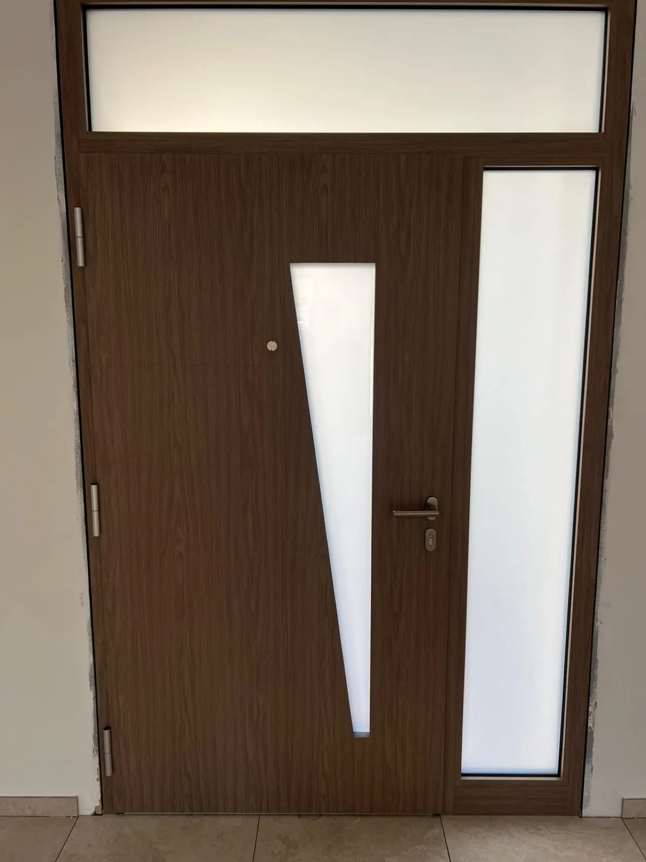 Dark flush-fitted front door with a glazed transom