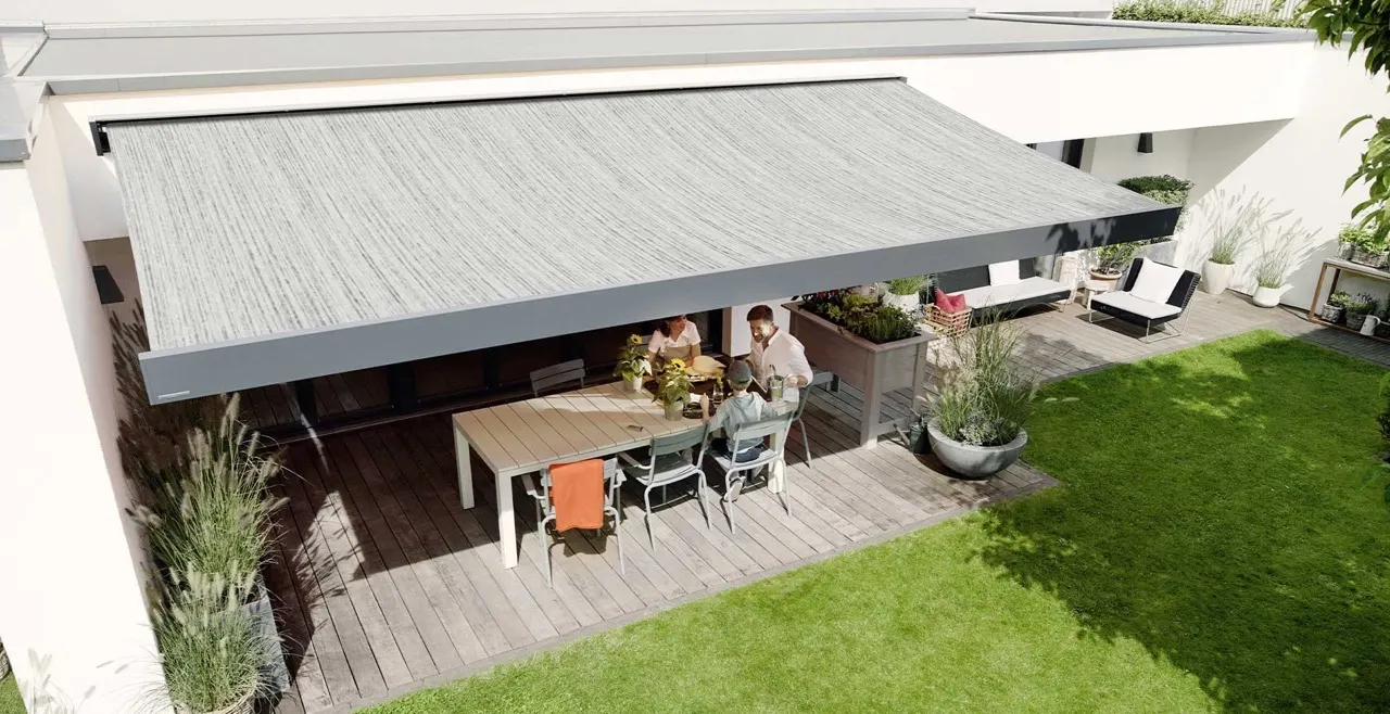 Folding-arm awning open over a terrace